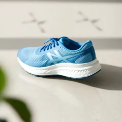 A blue running shoe on a light floor