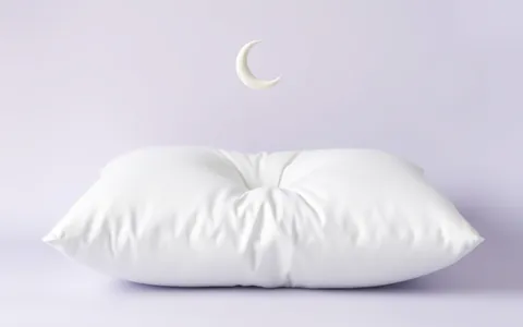 A white pillow with a small crescent moon above it
