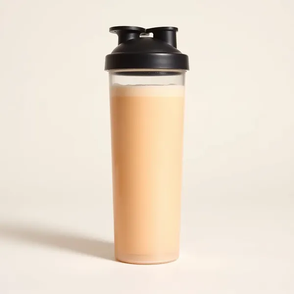 A peach shaker bottle with a creamy shake