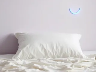 A white pillow under a crescent moon shape